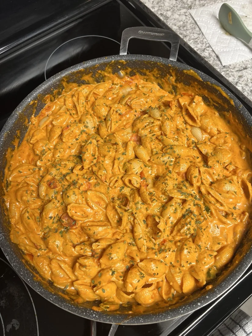 Creamy orange shell pasta with herbs
